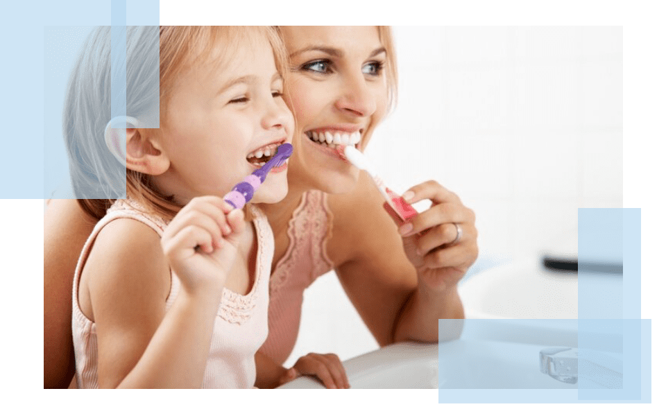 A woman and child brushing their teeth together.