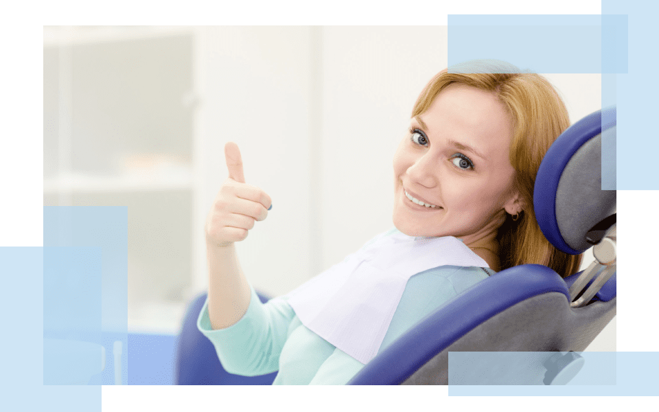 A woman sitting in an office chair giving the thumbs up.